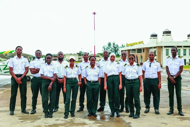 Aviation students and instructors beside a training aircraft